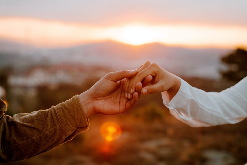 Couple holding hands in an article on emotional connection.